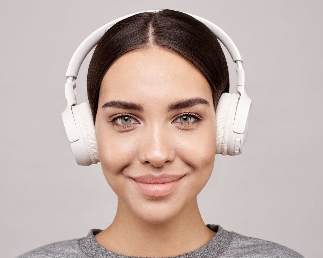 Listener wearing Vorlumi Aura headphones